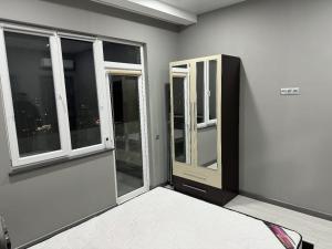 a room with two windows and a room with a bed at RS apartment in Batumi