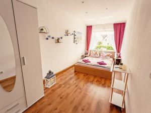 a small bedroom with a bed and a window at Urlaubsmagie- Pool, Terrasse, Barbecue - W4 in Lichtenhain