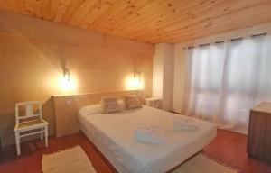 a bedroom with a white bed and a window at Torralta Tower House in Lagos