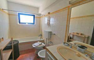 a bathroom with a tub and a toilet and a sink at Torralta Tower House in Lagos +25 photos