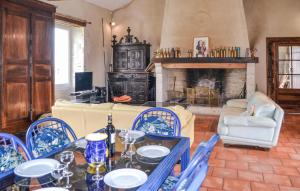 a living room with a table and chairs and a fireplace at Stunning Home In Fauroux With Wifi in Fauroux