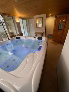 a large bath tub in a bathroom with at Maison 2 piscines int/ext, spa in Gueugnon