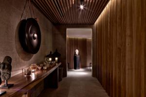 a hallway with a woman standing in the background at The Margi in Athens