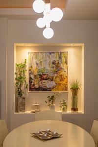 a dining room with a table and a painting at Morita Luxury Apartment in Heraklio