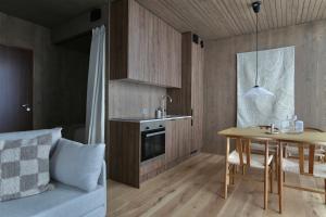 a kitchen with a table and a dining room at Saariselkä Villas by Hilla Villas in Saariselka