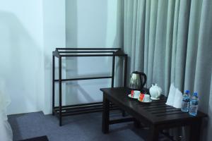 een kamer met een tafel met flessen water bij Queens Hotel in Udawalawe