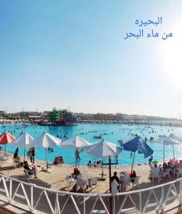 a group of people in the water at a beach at شالية قرية اللوتس in El Alamein
