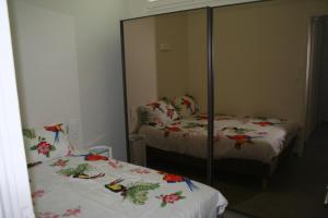 ル・テュケ・パリ・プラージュにあるHermite au Touquetのベッド2台と鏡付きのベッドルーム1室