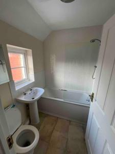 a bathroom with a toilet and a sink at 2 bed coach house flat Hereford in Hereford