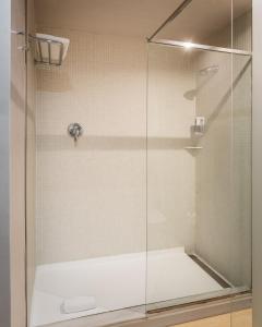 a shower with a glass door in a bathroom at Hotel Madanis in Barcelona