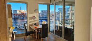a room with a desk with a view of a harbor at Ferienwohnung Neuer Hafen Marina in Bremerhaven