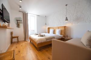 a hotel room with two beds and a couch at Montmartre lovers in Paris