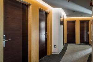 a hallway with wooden doors in a building at Hotel Madanis in Barcelona