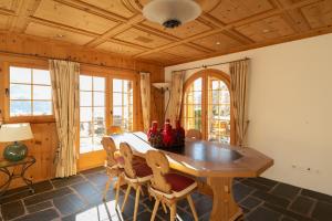 a dining room with a wooden table and chairs at Chalet Mira Golf in Sagogn