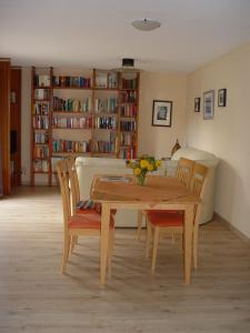 a dining room with a table and chairs and bookshelves at Arbshagen in Groß Kordshagen
