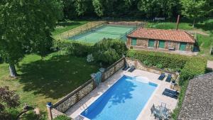 an overhead view of a pool and a tennis court at Keepers Cottage F in Bircham Newton