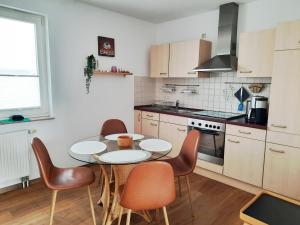 a kitchen with a table and chairs in it at Ferienwohnung 9 in der Strandstraße in Müritz