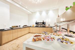 a kitchen with several bowls of food on a counter at Central City Hotel Rochat in Basel