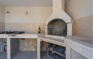 a kitchen with a bottle of wine on a counter at Gorgeous Home In Mandre With Wifi in Mandre +27 photos