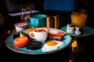 a plate of breakfast food on a table at Belmont Llandudno in Llandudno