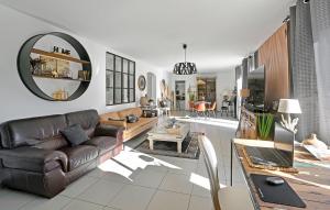 a living room with a couch and a table at 3 Bedroom Stunning Home In Bagnols-sur-cze in Bagnols-sur-Cèze