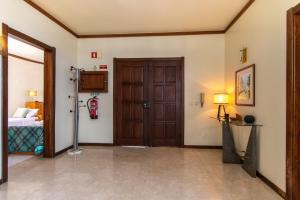 a room with a door and a bedroom with a bed at TAC - Vila Tina Vilamoura in Quarteira +36 photos