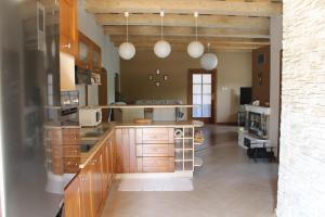 a large kitchen with wooden cabinets and white appliances at Privat pri Hradbach in Levoča