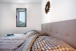 a bedroom with a bed with a mirror on the wall at Casa De Pedra in Porto Santo