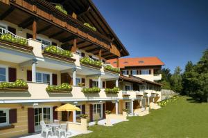 a large building with tables and chairs in a yard at Residenz Sonnenhang II in Füssen