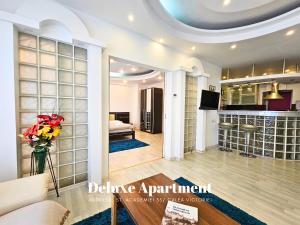 a living room with a couch and a vase of flowers at Rosuites Apartment Accommodation in Bucharest