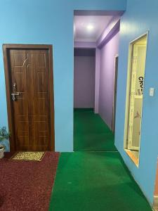 a room with a door and a green floor at Nagarkot Valley View Point Resort in Bhaktapur