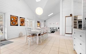 a white dining room with a white table and chairs at 4 Bedroom Lovely Home In Sjællands Odde in Yderby