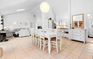 a white dining room with a white table and chairs at 4 Bedroom Lovely Home In Sjællands Odde in Yderby