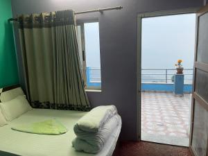 a bedroom with a bed and a sliding glass door at Nagarkot Valley View Point Resort in Bhaktapur