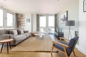 a living room with a couch and a table at The Bow Flats in London