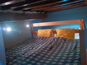 a bed in a bedroom with a blue wall at Dieppe Coeur de Ville in Dieppe