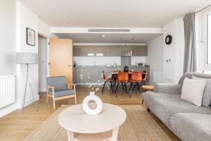 a living room with a couch and a table at The Bow Flats in London