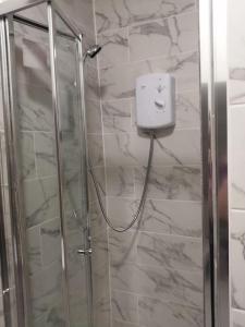 a bathroom with a shower with a glass door at Cosy City Apartment in Cork +27 photos