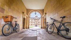 two bikes parked on the wall of a building at Cambridge Narrowboats - Beautiful Narrowboat Glyndwr in Cambridge