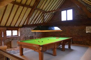 a pool table in a room with a ceiling at Barn conversion, Henley-on-Thames in Henley on Thames