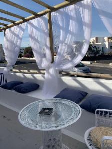 a glass table with a book on top of it on a table at Love story in Mala