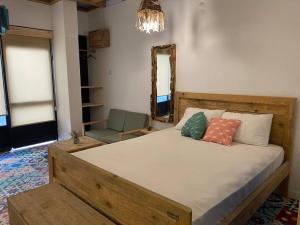 a bedroom with a bed with a mirror and a chair at Studio Nature of Sea in the city center in Antalya