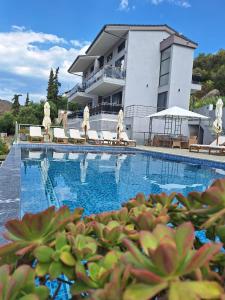 a large swimming pool in front of a building at Sarti Thea in Sarti