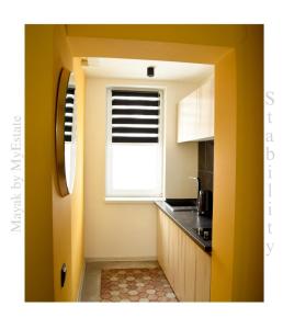 a small kitchen with a window and a sink at Aparthotel "Mayak Yablunytsia" in Yablunytsya