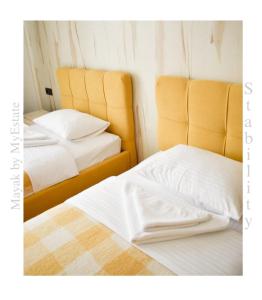 two beds sitting next to each other in a room at Aparthotel "Mayak Yablunytsia" in Yablunytsya