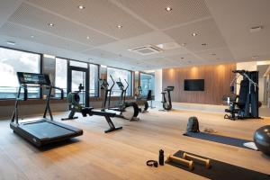 a gym with treadmills and exercise equipment in a building at Les Chalets Laska in Les Contamines-Montjoie