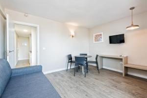 a living room with a couch and a table at Veramar Aparthotel in Fuengirola