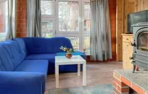 a blue couch in a living room with a table at Nice Home In Biendorf With Wi-fi in Biendorf