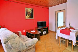 a living room with a couch and a table at Apartments Andelka G in Šilo