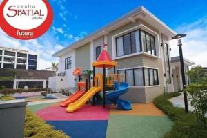 a house with a playground in front of it at Entire 2BR condo Centro Spatial Downtown in Davao City